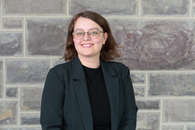 image of Madison Justice in front of Hokie Stone wall